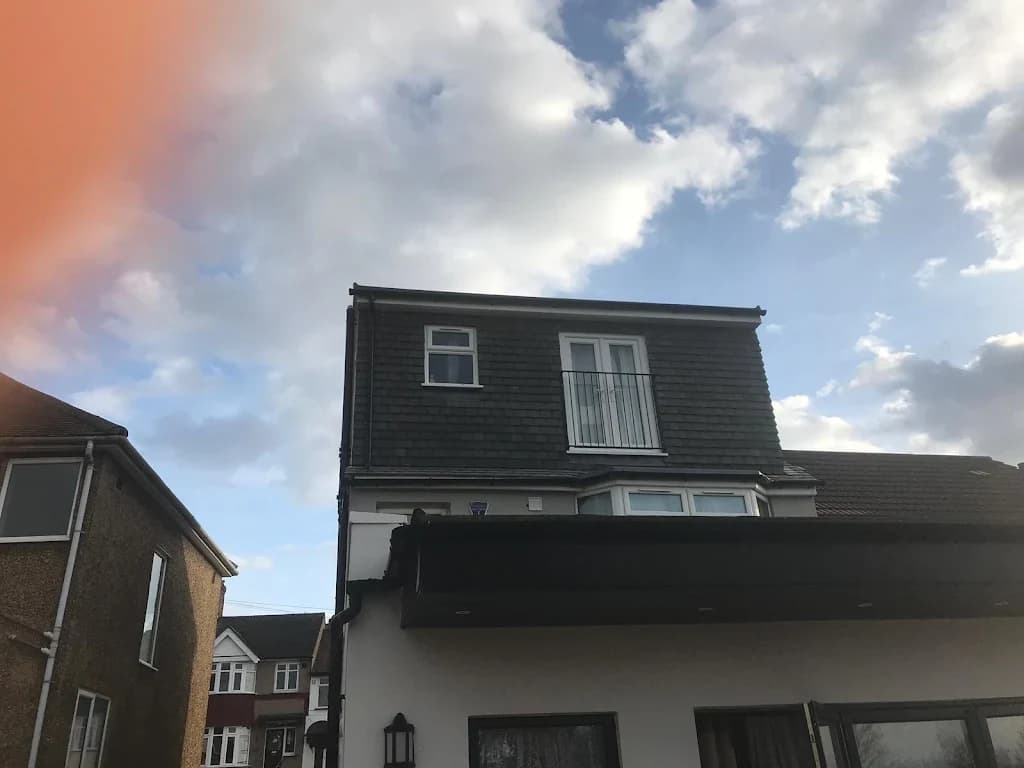 Completed rear dormer loft conversion with dark cladding in London