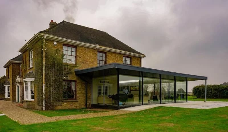 Stone house with contemporary glass extension