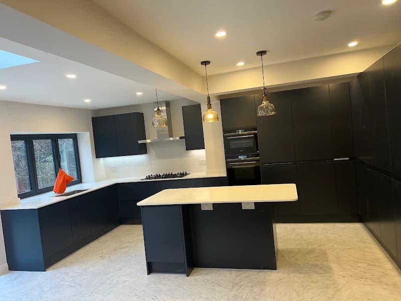 Dark kitchen with large island unit and pendant lighting