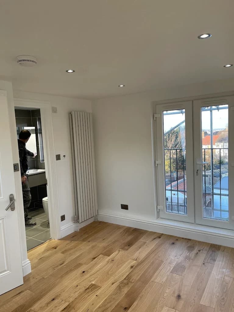 Completed loft room with skylight and wood floor in London